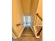 Carpeted stairway that leads to the entry door, with a wooden handrail and white banisters at 4970 Clubgreen Smt, Stone Mountain, GA 30088