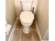 Close up of a standard white toilet on tile floor at 4970 Clubgreen Smt, Stone Mountain, GA 30088