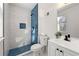 Modern bathroom with white tiled walls, blue tiled shower, and updated fixtures at 2139 Logan Dr, Jonesboro, GA 30236