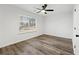 Bright, airy bedroom with wood flooring, ceiling fan, and large window at 2139 Logan Dr, Jonesboro, GA 30236