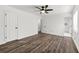 A bright bedroom features wood floors and a ceiling fan and a view of the bathroom at 2139 Logan Dr, Jonesboro, GA 30236