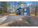 Two-story home with a blue exterior, complemented by a spacious front yard and mature trees at 2139 Logan Dr, Jonesboro, GA 30236