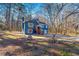 Two-story home with a blue exterior and a spacious front yard surrounded by towering trees at 2139 Logan Dr, Jonesboro, GA 30236