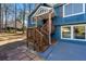 Side view of a house with a charming wooden staircase, an orange door, and blue siding at 2139 Logan Dr, Jonesboro, GA 30236
