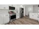 Updated kitchen featuring stainless steel appliances, white cabinets and countertops at 2139 Logan Dr, Jonesboro, GA 30236