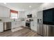 Renovated kitchen with stainless steel appliances and bright white backsplash and cabinets at 2139 Logan Dr, Jonesboro, GA 30236