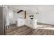 Open concept kitchen with island, bright white cabinets, hardwood style flooring and fireplace at 2139 Logan Dr, Jonesboro, GA 30236