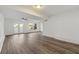 Bright living room featuring wood-look floors, modern lighting, and access to outdoor space at 2139 Logan Dr, Jonesboro, GA 30236