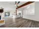Open-concept living space featuring wood floors, fireplace, and seamless flow to the modern kitchen at 2139 Logan Dr, Jonesboro, GA 30236