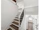 Stairway with wooden steps and white risers and black metal railings at 2139 Logan Dr, Jonesboro, GA 30236