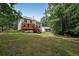 Expansive backyard featuring a deck, lush lawn, and picturesque views at 3265 Greenhill Ct, Villa Rica, GA 30180
