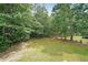 A backyard with lush green grass and mature trees, perfect for outdoor activities at 3265 Greenhill Ct, Villa Rica, GA 30180