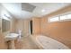 Bathroom featuring a white pedestal sink, toilet, and a relaxing soaking tub at 3265 Greenhill Ct, Villa Rica, GA 30180
