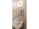 Charming powder room featuring a pedestal sink and decorative mirror at 3265 Greenhill Ct, Villa Rica, GA 30180