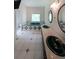 Bathroom featuring double sinks, large mirrors, diamond tile, and a jacuzzi tub under a bright window at 3265 Greenhill Ct, Villa Rica, GA 30180