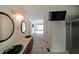 Bathroom with double sinks, large mirrors and a view of the living room with hardwood floors at 3265 Greenhill Ct, Villa Rica, GA 30180