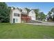 Multi-story home with a red porch and attached garage, nestled in a lush green lawn with a lengthy driveway at 3265 Greenhill Ct, Villa Rica, GA 30180