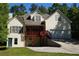 Charming multi-story home boasts a red porch, lush surroundings, and convenient driveway access to the garage at 3265 Greenhill Ct, Villa Rica, GA 30180