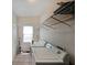 Functional laundry room featuring tile floors, washer, dryer, and storage shelves at 3265 Greenhill Ct, Villa Rica, GA 30180