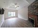 Bright living room with hardwood floors, stone fireplace, recessed lighting, and ceiling fan at 3265 Greenhill Ct, Villa Rica, GA 30180