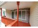 Cozy porch featuring stone accents, a wooden floor, and vibrant red railings, perfect for outdoor enjoyment at 3265 Greenhill Ct, Villa Rica, GA 30180