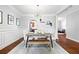 Stylish dining room featuring modern light fixture, wainscoting and hardwood floors at 3690 Lambert Ne Ln, Atlanta, GA 30319
