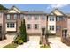 Charming brick townhome featuring a one-car garage and well-maintained landscaping at 3690 Lambert Ne Ln, Atlanta, GA 30319