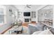Cozy living room boasts a fireplace, built-in shelves, and lots of natural light at 3690 Lambert Ne Ln, Atlanta, GA 30319