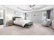 This primary bedroom features a tray ceiling, sitting area, and ensuite bath at 3690 Lambert Ne Ln, Atlanta, GA 30319