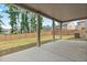 Backyard covered patio with concrete base and grassy lawn at 4117 Flat Rock Pt, Stonecrest, GA 30038