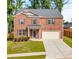 Beautiful two-story brick home with a well-manicured lawn and a two-car garage at 4117 Flat Rock Pt, Stonecrest, GA 30038