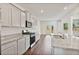 Modern kitchen with white cabinetry, granite countertops, stainless steel appliances, and hardwood floors at 4117 Flat Rock Pt, Stonecrest, GA 30038