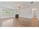 Large living room with hardwood floors, fireplace, ceiling fan, and abundant natural light from a large window at 4117 Flat Rock Pt, Stonecrest, GA 30038