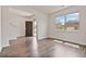 Living room with hardwood flooring, a large window, and front door view at 4117 Flat Rock Pt, Stonecrest, GA 30038