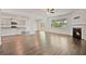 Open living area with hardwood floors, fireplace, and seamless flow to the kitchen and outdoor access at 4117 Flat Rock Pt, Stonecrest, GA 30038