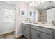 Bathroom with double sink vanity, large mirror, and a glass enclosed shower at 639 Tigers Eye Ter, Kennesaw, GA 30144