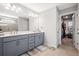Bathroom with double sink vanity, large mirror, and walk in closet at 639 Tigers Eye Ter, Kennesaw, GA 30144