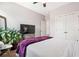 Comfortable bedroom with a large TV, plant, and double door closet at 639 Tigers Eye Ter, Kennesaw, GA 30144