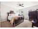 Bedroom with ornate wood bed frame, plush carpet, windows and a dark wood dresser at 639 Tigers Eye Ter, Kennesaw, GA 30144