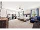 Spacious bedroom featuring a ceiling fan, large windows, seating, desk and workout equipment at 639 Tigers Eye Ter, Kennesaw, GA 30144