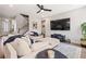 Comfortable living room featuring plush seating, a ceiling fan, and a large television screen at 639 Tigers Eye Ter, Kennesaw, GA 30144
