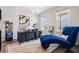 Bright home office with dark wood floors, large windows, and a chaise lounge at 639 Tigers Eye Ter, Kennesaw, GA 30144