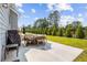 Spacious patio with table and chairs, grill, and green lawn at 639 Tigers Eye Ter, Kennesaw, GA 30144