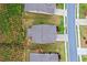 Aerial view of a landscaped property with lawn, driveway, and surrounding trees at 151 Rolling Hills Pl, Canton, GA 30114