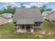 Aerial view of backyard with covered patio, grill, and a grassy fenced-in area at 151 Rolling Hills Pl, Canton, GA 30114