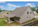 Exterior back view of home featuring a covered patio, grill, and fenced in yard at 151 Rolling Hills Pl, Canton, GA 30114