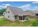 Back exterior view of home featuring a covered patio and grill overlooking the grassy yard at 151 Rolling Hills Pl, Canton, GA 30114