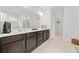Bright bathroom with double vanity, white countertops, and dark wood cabinets at 151 Rolling Hills Pl, Canton, GA 30114