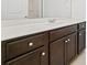Bathroom vanity with a solid surface countertop, dark wood cabinets, and a sink with chrome faucet at 151 Rolling Hills Pl, Canton, GA 30114