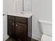 Modern powder room with dark wood vanity and white countertop at 151 Rolling Hills Pl, Canton, GA 30114